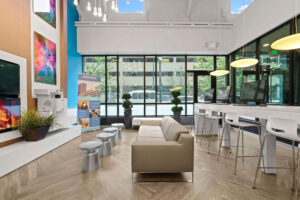 a room with a couch and tables and chairs
