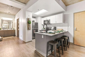 a kitchen with a bar and stools