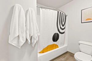 a shower curtain and towels in a bathroom