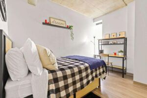 a room with a bed and desk