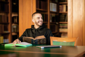 a man sitting at a table with a book