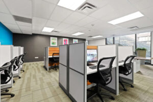 a room with cubicles and computers