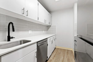a kitchen with white cabinets and stainless steel appliances