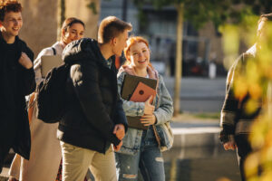 a group of people walking on a sidewalk
