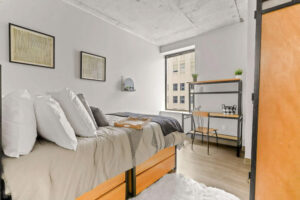 a bedroom with a bed and a desk