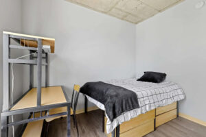a bed with a desk and chair in a room
