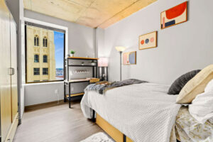 a bedroom with a bed and a window