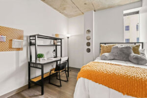 a room with a bed and desk