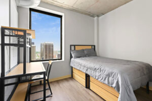 a bedroom with a bed and desk