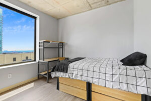 a bedroom with a bed and desk