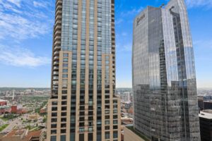 a group of tall buildings with glass windows