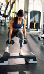 a woman lifting weights in a gym