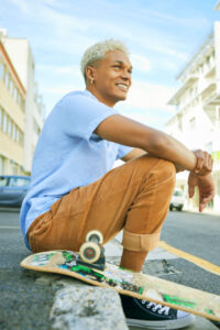 a man sitting on a skateboard